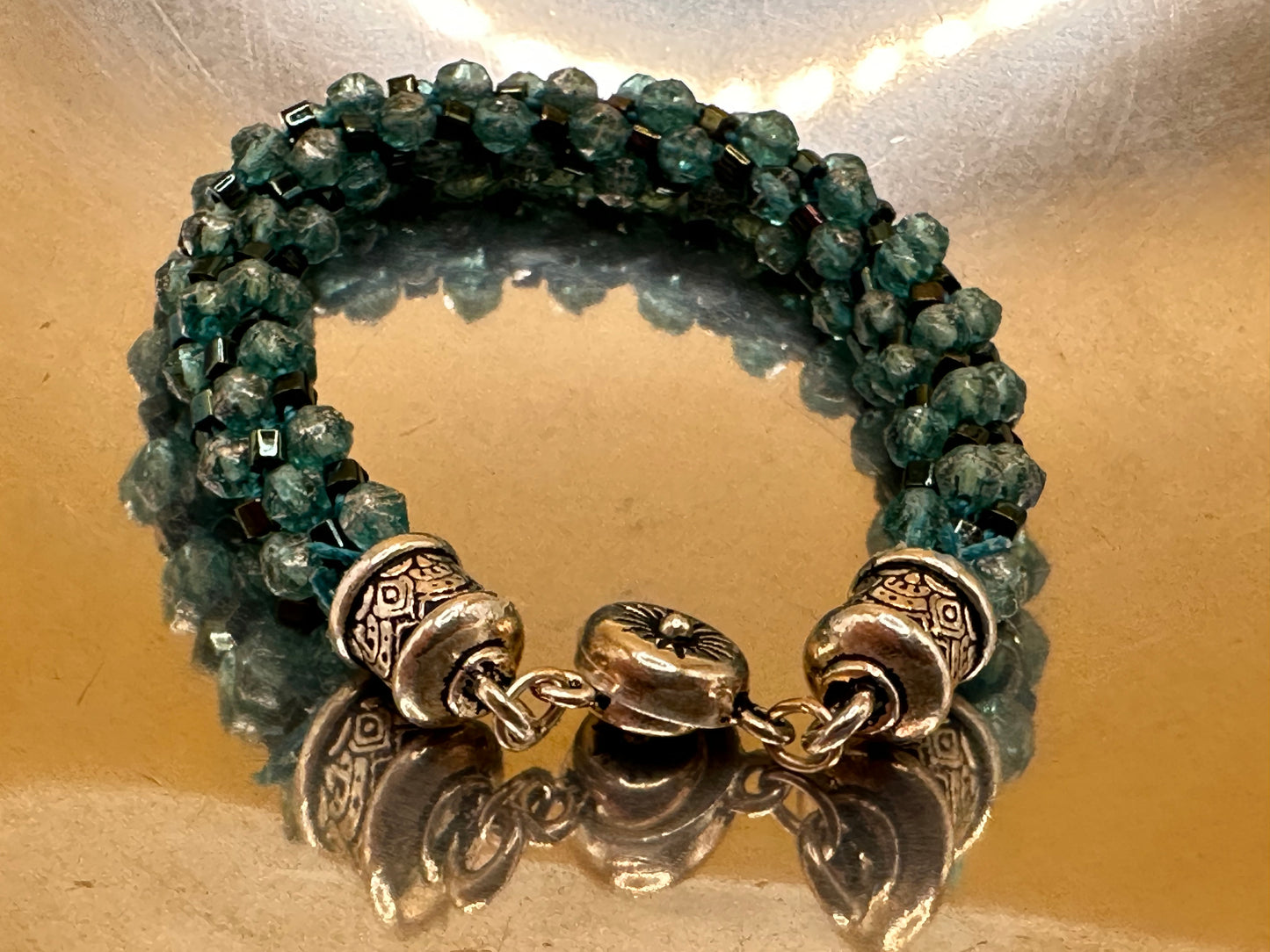 Kumihimo (Japanese braided)  Spiral Bracelet featuring green frosted bicone crystals