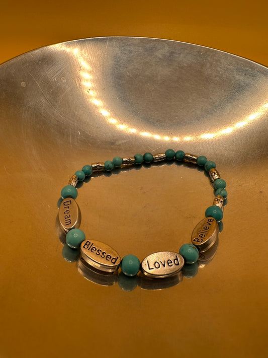 Blue Turquoise natural stone stretch bracelet with silver toned charm plates.