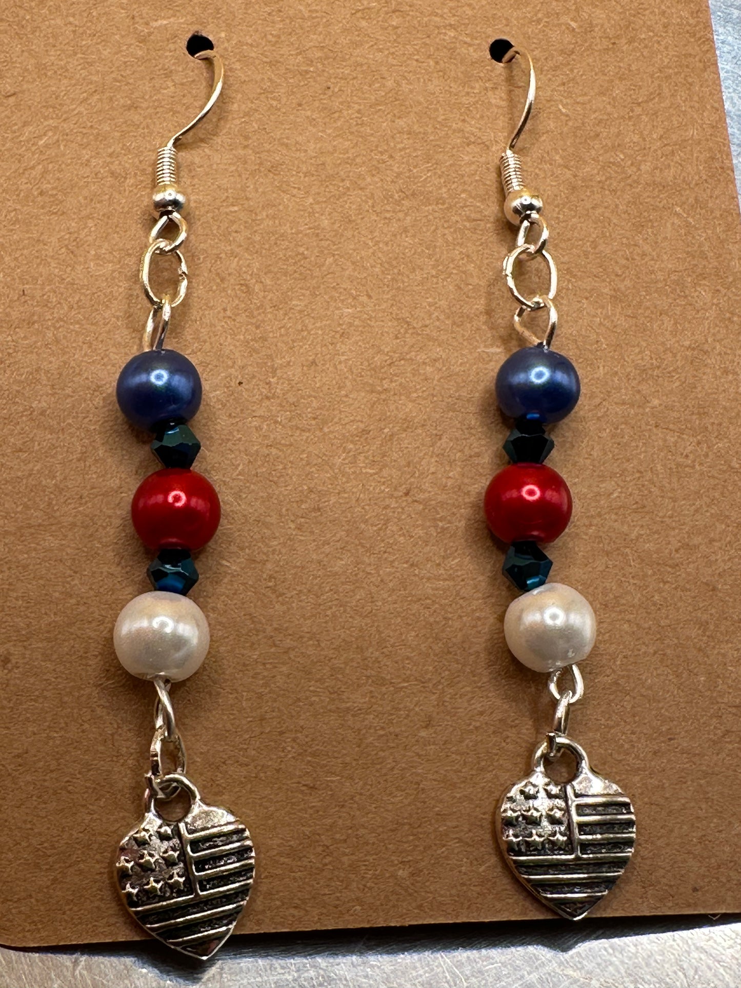 Patriotic Red White and Blue beaded earrings with blue bicone spacer beads with Heart/Flag charm and sterling silver ear wires.