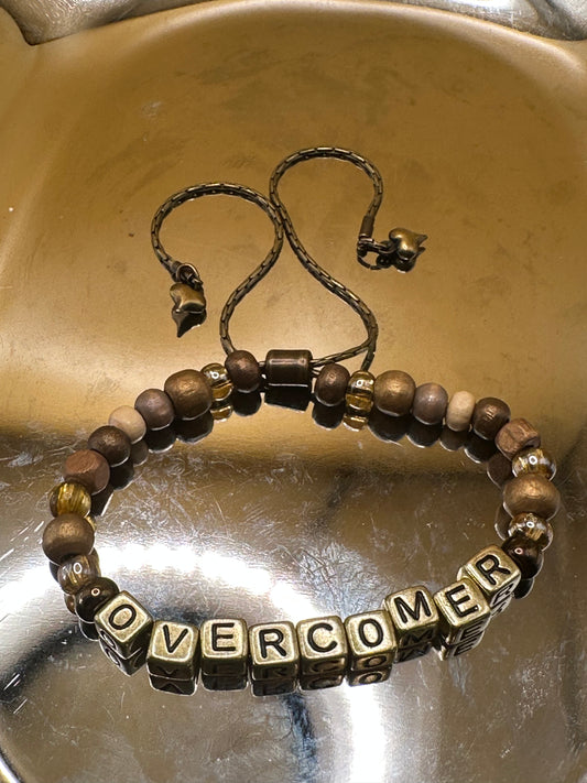 Antique brass beaded "Overcomer" bracelet with adjustable clasp and brass heart charms.
