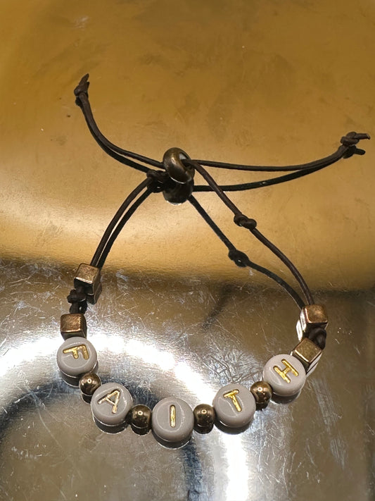 Dark brown leather adjustable bracelet with "Faith" white/gold round beads.