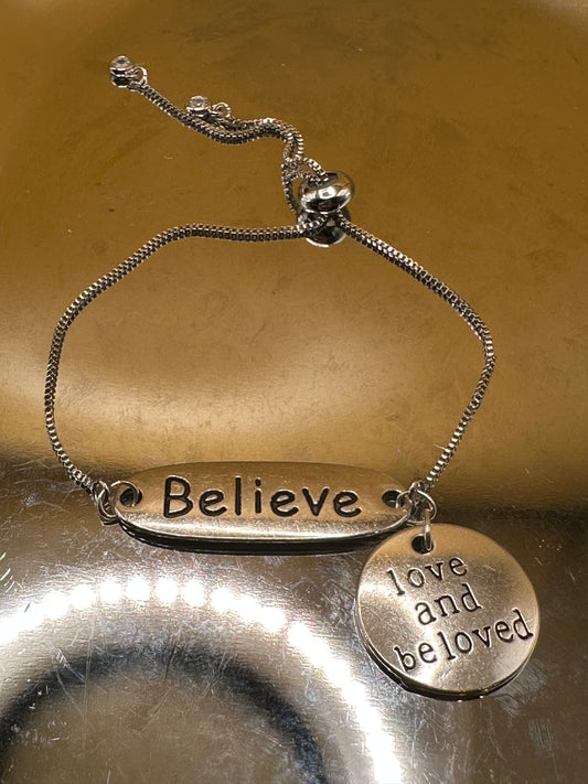 Silver plated adjustable bracelet with "Believe" focal and "Love and Be Loved" charm.