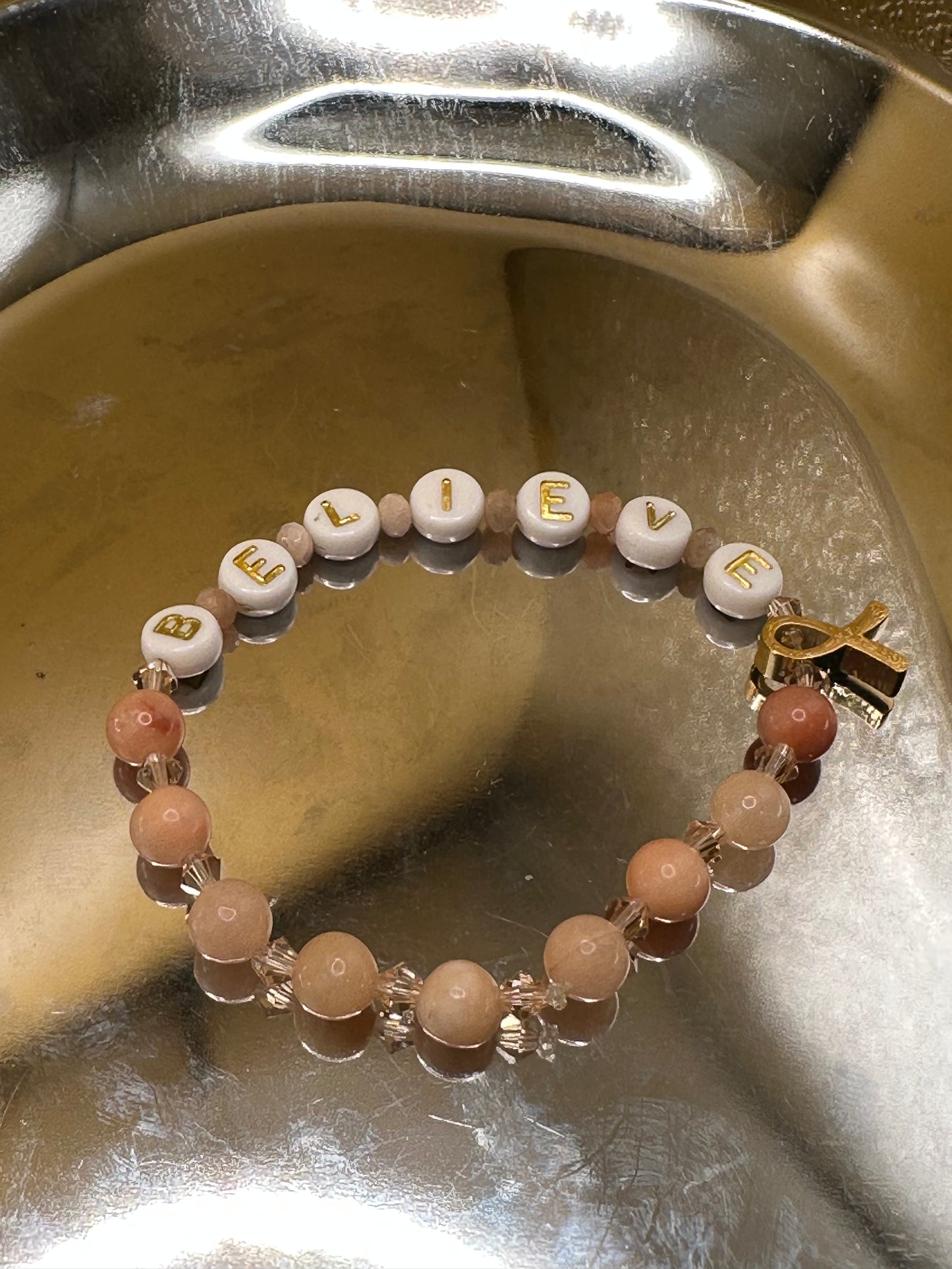 Peach (Uterine Cancer Awareness) Bracelet with round 6mm Jade semi precious stone beads with 4mm Austrian Bicone crystals and Rondelle Moonstone beads; Gold/white round "Believe" with gold toned ribbon charm.