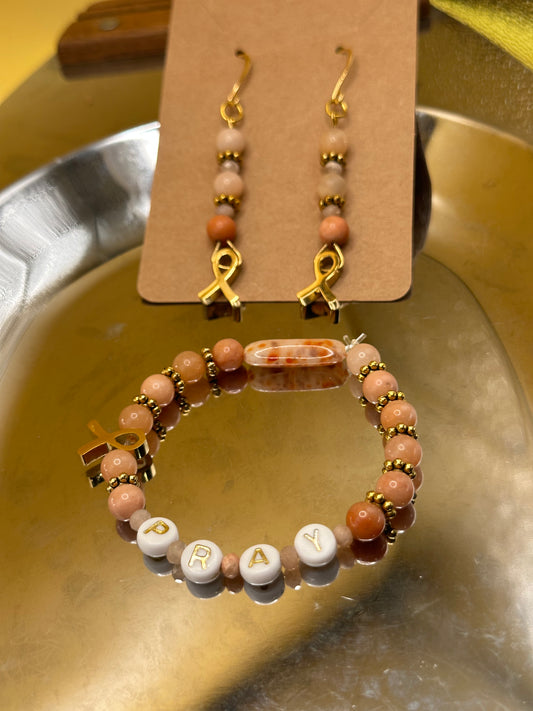 Peach (Uterine Cancer Awareness) Bracelet and Earring set featuring Peach Jade semi precious round stones with Rondelle Moonstone semi precious beads.Gold/white round "Pray" beads and gold toned cancer ribbon charm.
